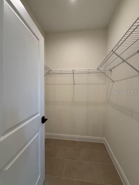 spacious closet featuring tile patterned floors