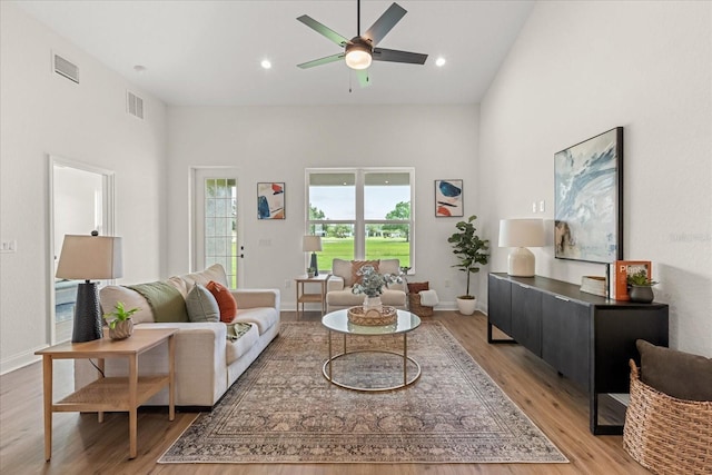 5277 Pebble Beach Dr, Sebring, FL 33872 - living area with light wood-style flooring, a ceiling fan, a towering ceiling, and recessed lighting