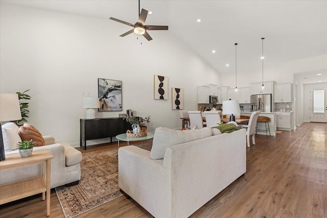 5277 Pebble Beach Dr, Sebring, FL 33872 - living room featuring high vaulted ceiling, a ceiling fan, recessed lighting, and light wood-style flooring