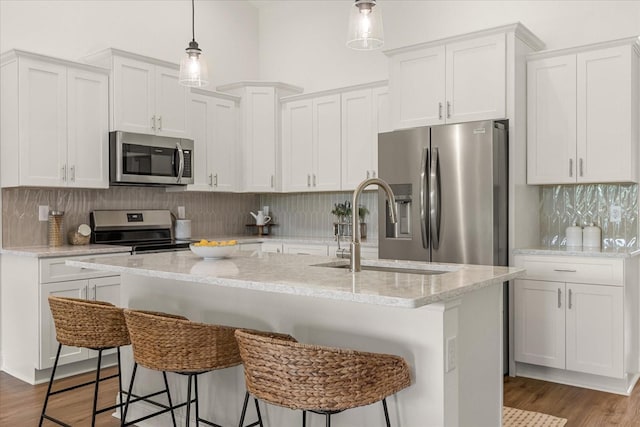 5277 Pebble Beach Dr, Sebring, FL 33872 - kitchen with appliances with stainless steel finishes, white cabinetry, and decorative backsplash