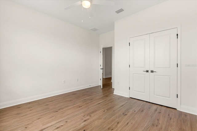 5277 Pebble Beach Dr, Sebring, FL 33872 - unfurnished bedroom featuring light wood-style floors, a closet, and a ceiling fan