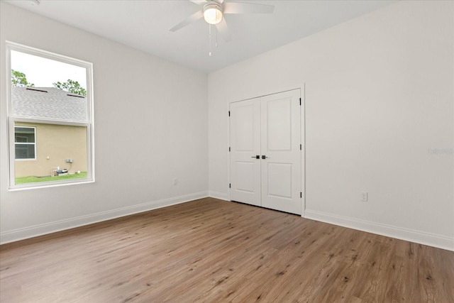 5277 Pebble Beach Dr, Sebring, FL 33872 - unfurnished bedroom featuring light wood-style floors, a closet, and a ceiling fan