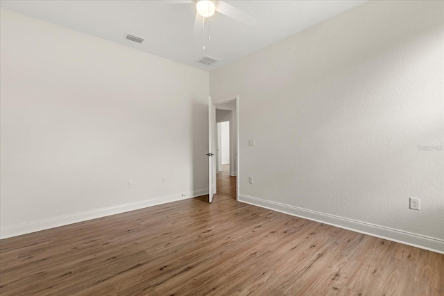 5277 Pebble Beach Dr, Sebring, FL 33872 - spare room featuring wood finished floors and a ceiling fan