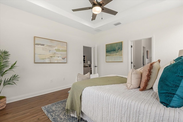 5277 Pebble Beach Dr, Sebring, FL 33872 - bedroom featuring wood finished floors, a tray ceiling, and a ceiling fan