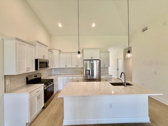 5273 Pebble Beach Dr, Sebring, FL 33872 - kitchen with high vaulted ceiling, a large island with sink, a sink, backsplash, and stainless steel appliances