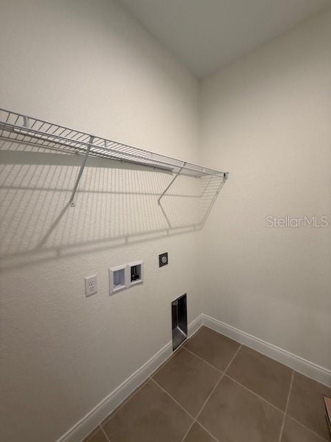 5273 Pebble Beach Dr, Sebring, FL 33872 - clothes washing area with hookup for an electric dryer, laundry area, dark tile patterned flooring, baseboards, and hookup for a washing machine