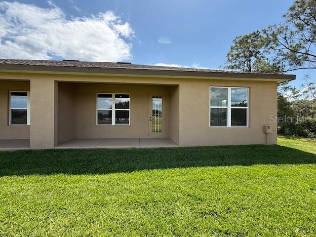 5273 Pebble Beach Dr, Sebring, FL 33872 - rear view of house featuring stucco siding, a yard, and a patio area