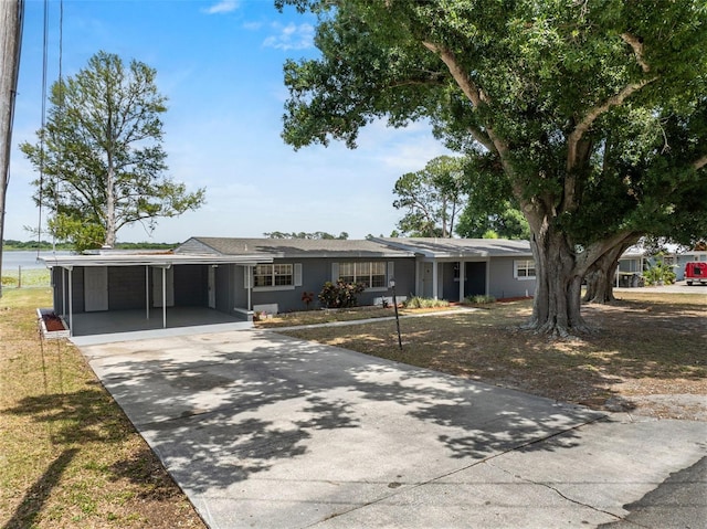 single story home with driveway and a carport