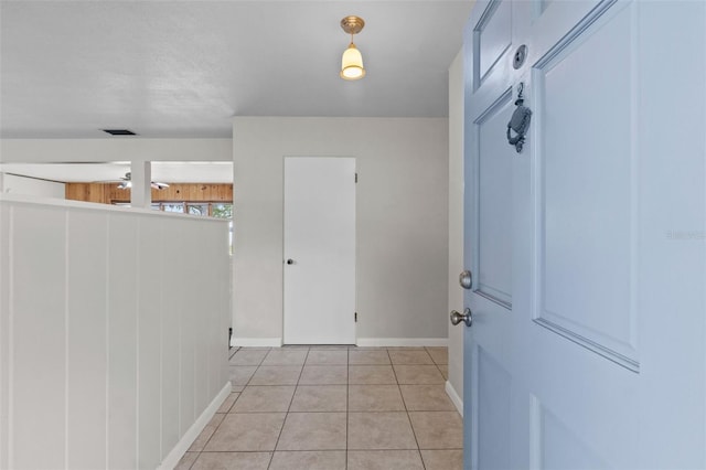 interior space with baseboards, visible vents, and light tile patterned flooring