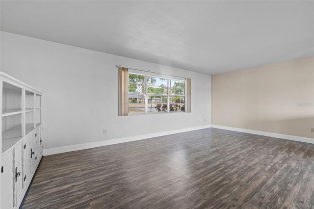 interior space with baseboards and dark wood-style floors