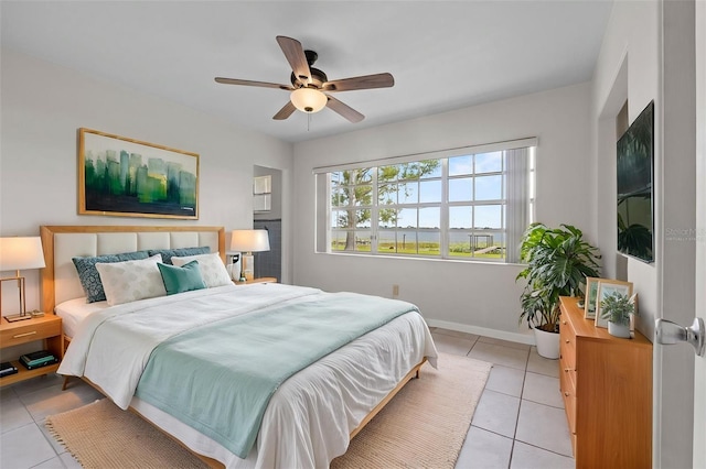 bedroom with light tile patterned floors, baseboards, and ceiling fan
