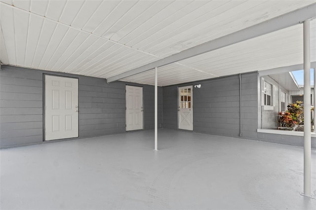 exterior space with concrete block wall
