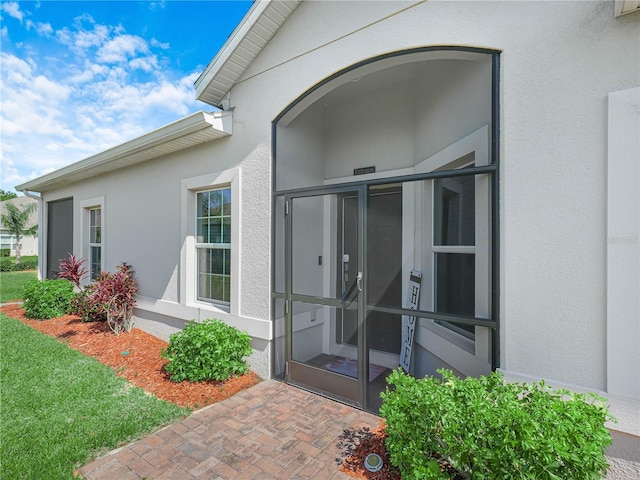 entrance to property with stucco siding