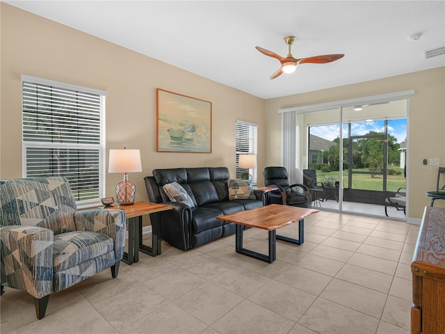 living area featuring ceiling fan, light tile patterned floors, and visible vents