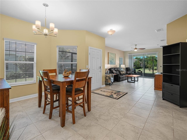 dining space featuring light tile patterned floors, ceiling fan with notable chandelier, baseboards, and visible vents