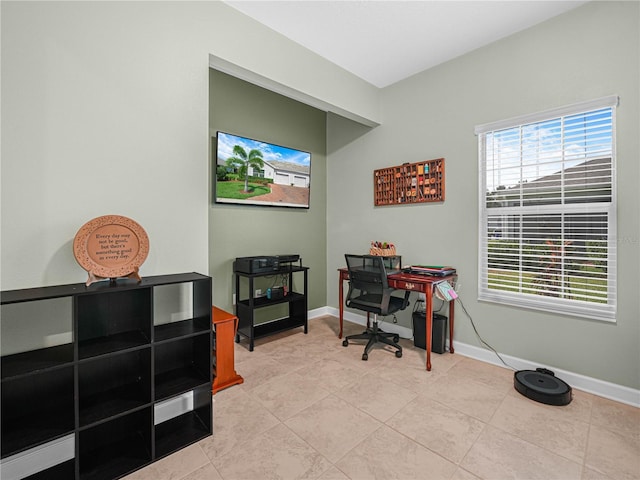 office space featuring baseboards and light tile patterned floors
