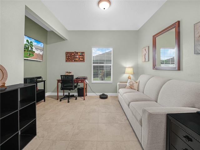 office area with light tile patterned floors and baseboards