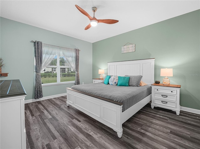 bedroom with baseboards, dark wood-type flooring, and a ceiling fan
