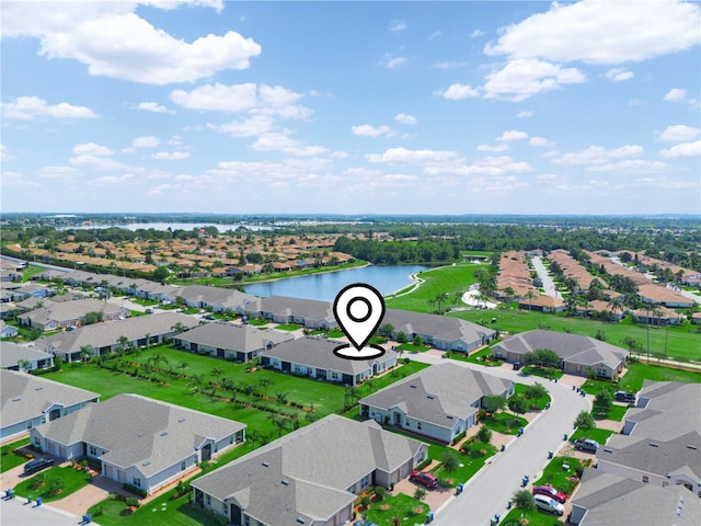bird's eye view featuring a water view and a residential view
