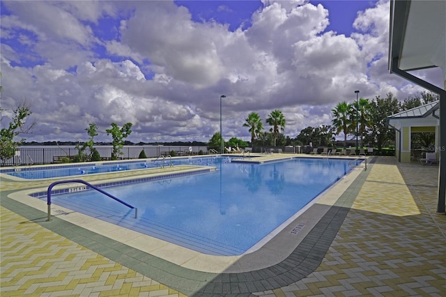 community pool featuring a patio area and fence