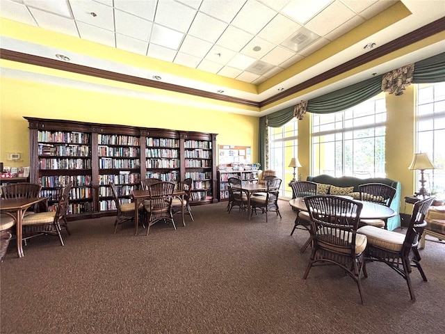 sitting room with crown molding, a raised ceiling, carpet floors, and visible vents