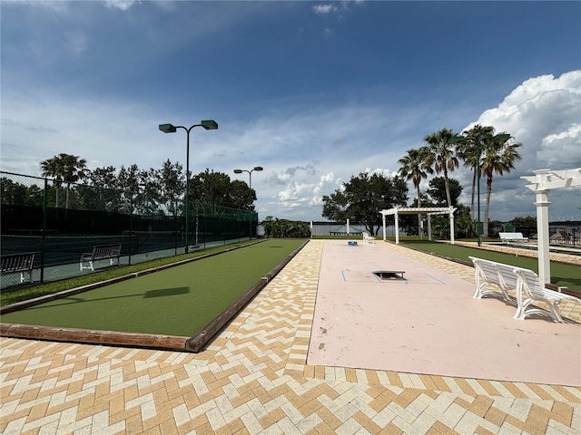 view of property's community with a pergola and fence