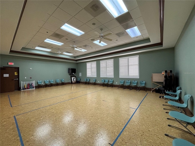 interior space featuring a tray ceiling, baseboards, and a paneled ceiling