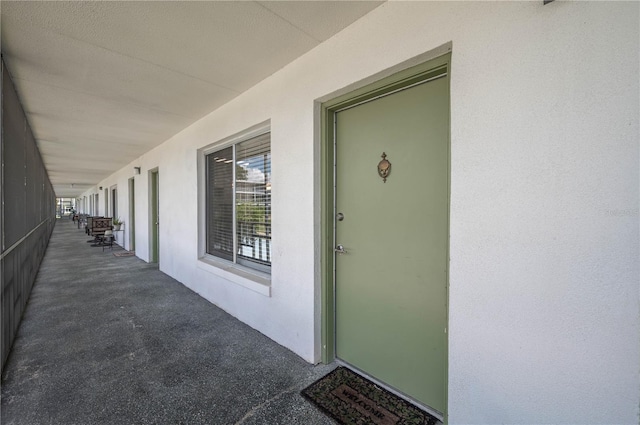 view of exterior entry featuring stucco siding