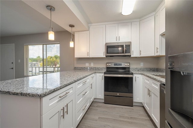 kitchen with a peninsula, stainless steel appliances, light wood finished floors, white cabinets, and light stone countertops