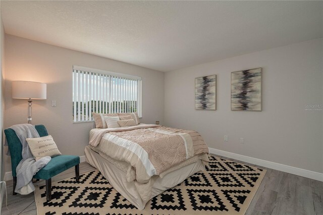 1700 6th St NW Unit C26, Winter Haven, FL 33881 - bedroom with baseboards and light wood-type flooring