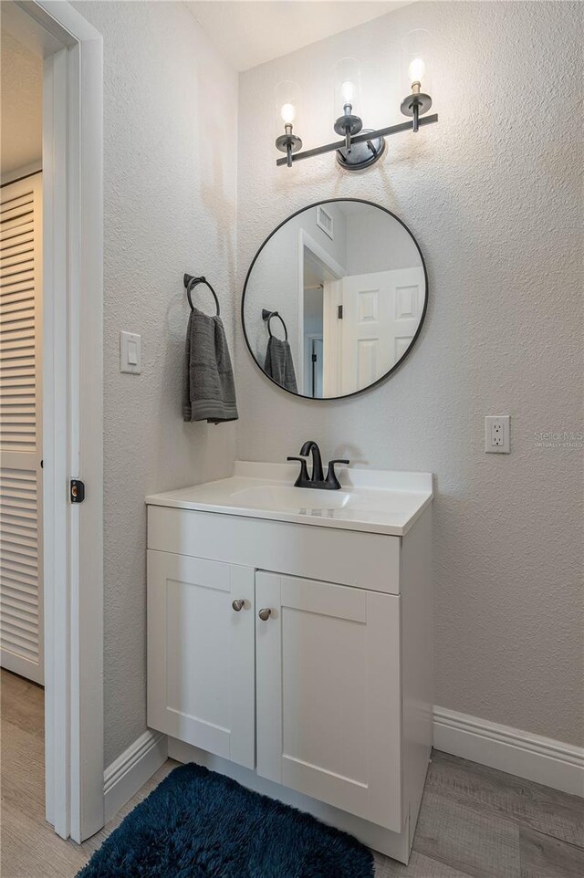 1700 6th St NW Unit C26, Winter Haven, FL 33881 - bathroom featuring baseboards and vanity