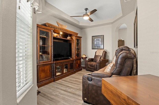 135 Minniehaha Cir, Haines City, FL 33844 - living room featuring arched walkways, ceiling fan, and light wood finished floors