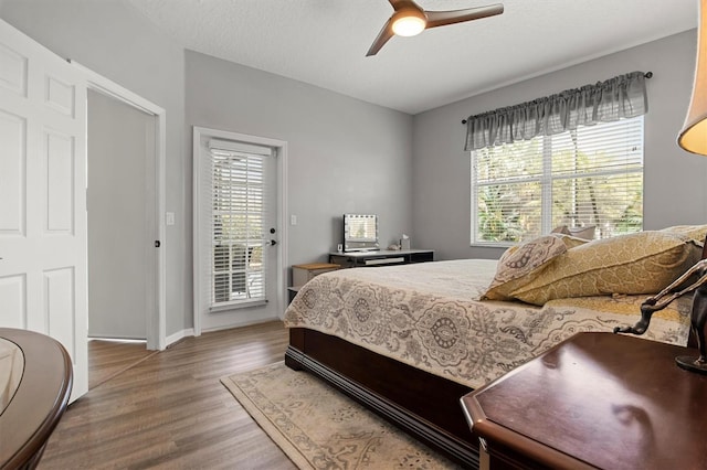 135 Minniehaha Cir, Haines City, FL 33844 - bedroom featuring wood finished floors, access to outside, a ceiling fan, and baseboards