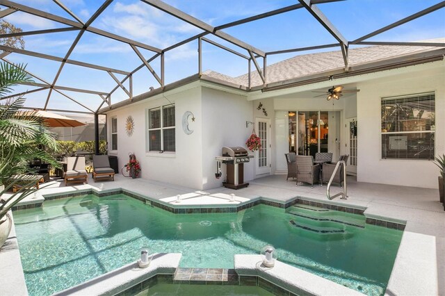 135 Minniehaha Cir, Haines City, FL 33844 - view of pool with a patio area, area for grilling, ceiling fan, a pool with connected hot tub, and glass enclosure