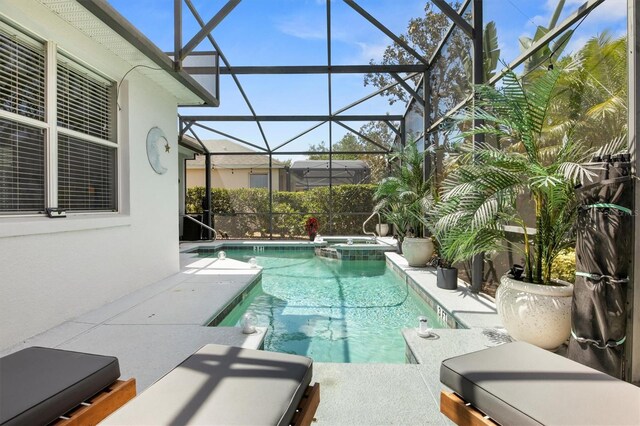 135 Minniehaha Cir, Haines City, FL 33844 - view of pool with glass enclosure, a pool with connected hot tub, and a patio area