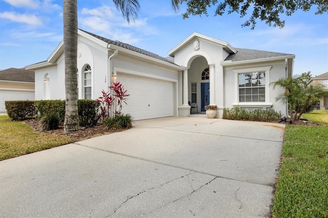135 Minniehaha Cir, Haines City, FL 33844 - ranch-style house with stucco siding, an attached garage, and concrete driveway