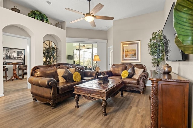 135 Minniehaha Cir, Haines City, FL 33844 - living room featuring wood finished floors, a ceiling fan, and baseboards