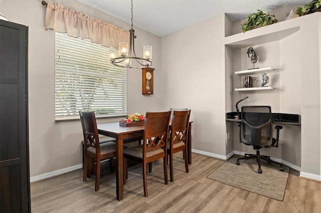 135 Minniehaha Cir, Haines City, FL 33844 - dining space featuring a chandelier, light wood finished floors, baseboards, and a desk