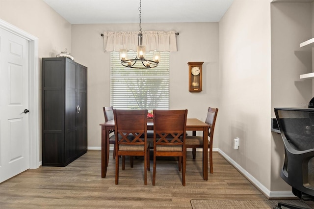 135 Minniehaha Cir, Haines City, FL 33844 - dining area with a chandelier, light wood finished floors, and baseboards