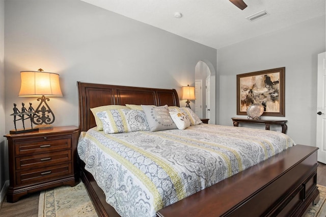 135 Minniehaha Cir, Haines City, FL 33844 - bedroom featuring wood finished floors, arched walkways, baseboards, and a ceiling fan