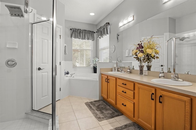 135 Minniehaha Cir, Haines City, FL 33844 - full bath featuring a stall shower, a bath, double vanity, and tile patterned flooring