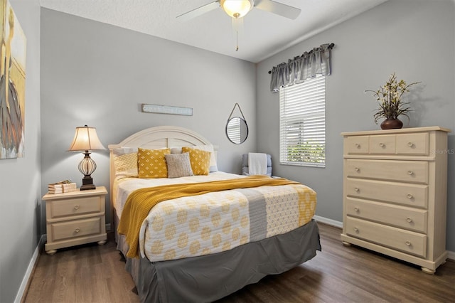 135 Minniehaha Cir, Haines City, FL 33844 - bedroom featuring dark wood-style floors, baseboards, and a ceiling fan