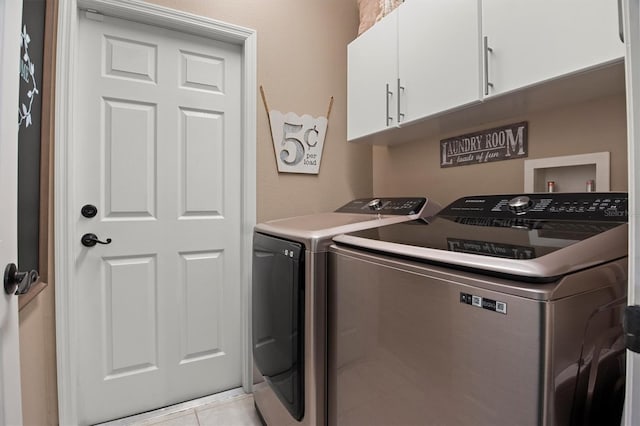 135 Minniehaha Cir, Haines City, FL 33844 - washroom featuring washing machine and clothes dryer, cabinet space, and light tile patterned floors