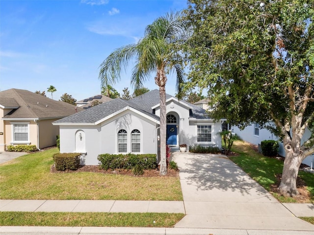 135 Minniehaha Cir, Haines City, FL 33844 - ranch-style home featuring a front yard, stucco siding, driveway, and roof with shingles