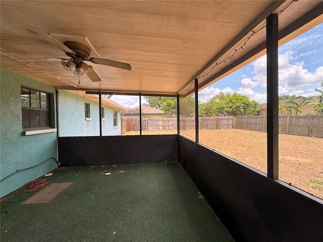 unfurnished sunroom featuring a ceiling fan and healthy amount of natural light