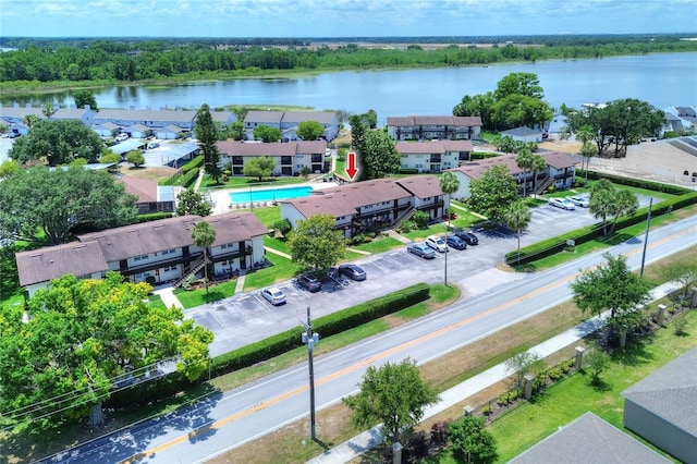 drone / aerial view of a large body of water and a pool area