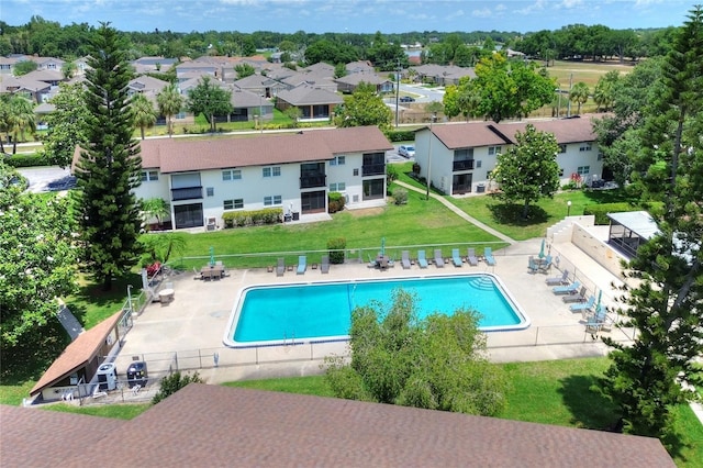 community pool with a patio area and a residential view