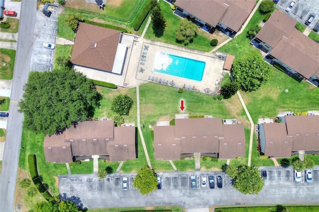 aerial overview of property's location with a pool and nearby suburban area