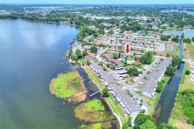 aerial view of property's location with a large body of water and nearby suburban area