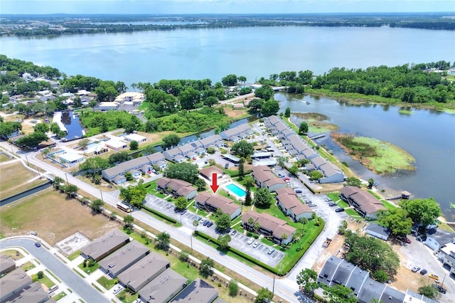 aerial view of property's location with a nearby body of water and nearby suburban area